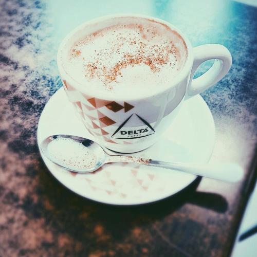 モンティジョにあるHotel Gran Sol De Extremaduraの皿に盛ったコーヒーとスプーン