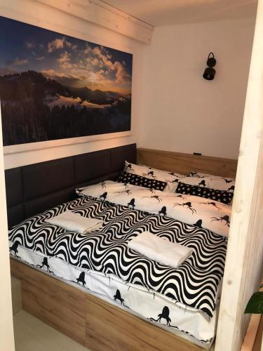 a bed in a bedroom with a zebra patterned mattress at Apartament BeSkidSki in Szczyrk