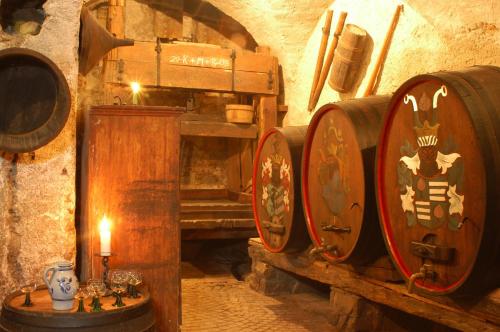 a group of wine barrels in a cellar at Hotel Öhlerhof in Lagundo