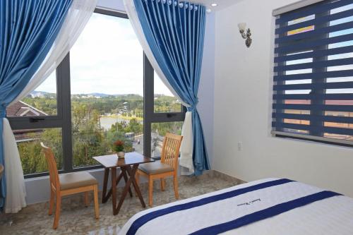 1 dormitorio con cama, mesa y ventana en Luan'S Villa en Da Lat