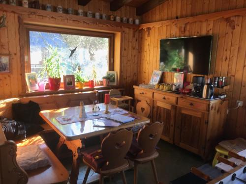 a dining room with a table and a window at Maier Chalet in Bayerisch Eisenstein