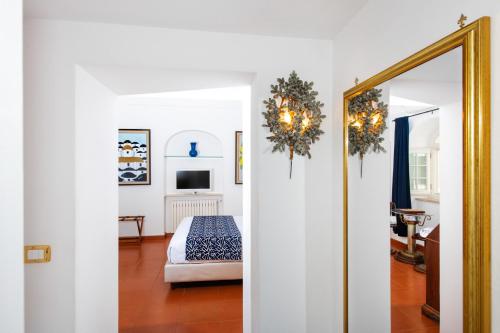 a room with a bed and a mirror at La Casa di Peppe in Positano