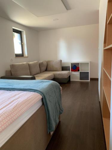 a living room with a bed and a couch at Holiday house Nune in Zreče