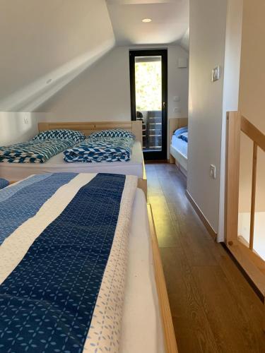 a bedroom with two beds and a window at Holiday house Nune in Zreče