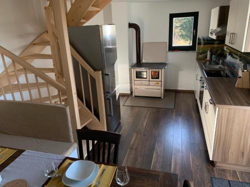 cocina con mesa y cocina con escalera en Holiday house Nune, en Zreče