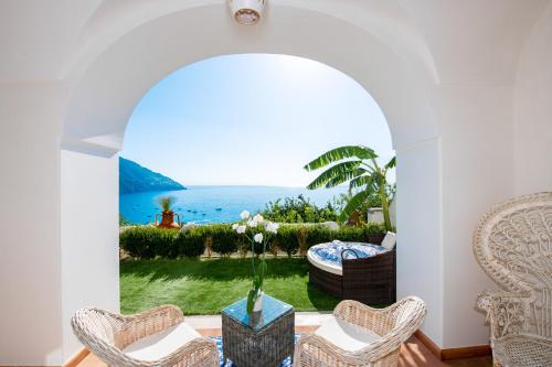 a room with a table with a view of the ocean at La Casa di Peppe in Positano