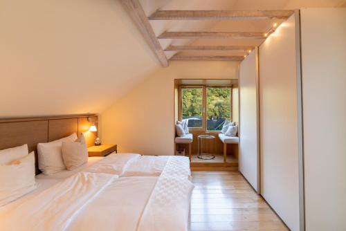 a bedroom with a large white bed in a room at Villa Waldesruh in Siegburg