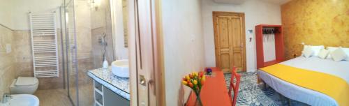 a bedroom with a bed and a bathroom with a shower at Casa Orrù in Nuoro