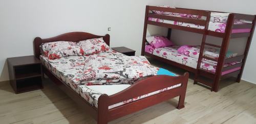 a bedroom with a bed and a bunk bed at PROKLETIJE eko katun Vusanje in Gusinje