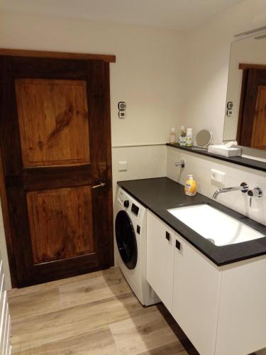 a kitchen with a sink and a washing machine at Ferienwohnung Schmallenberg in Schmallenberg
