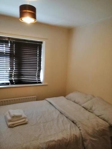 a bedroom with a bed with two towels on it at Memory Homes MM H in Manchester