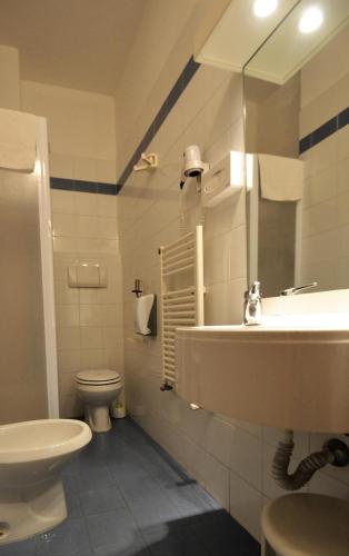 a bathroom with a sink and a toilet at Hotel Posta in Cecina