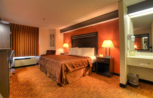 a hotel room with a bed and a window at Smoky Mountain Inn & Suites in Cherokee