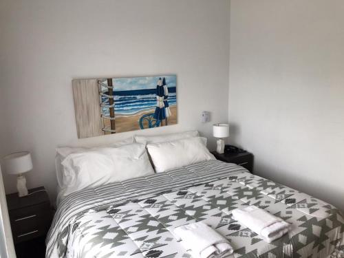 a bedroom with a bed and a painting on the wall at Hotel Europa in Ostende