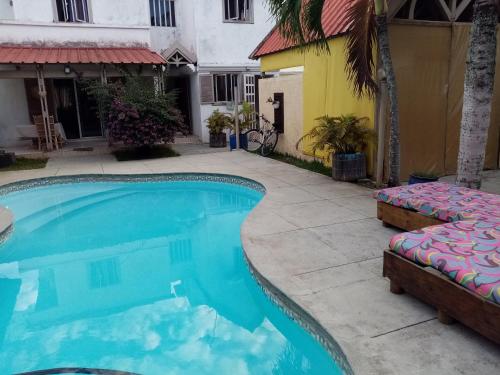 a swimming pool in front of a house at Chez nous in Pereybere