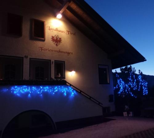 a building with blue lights on the side of it at Landhaus Tirol in Presseggersee