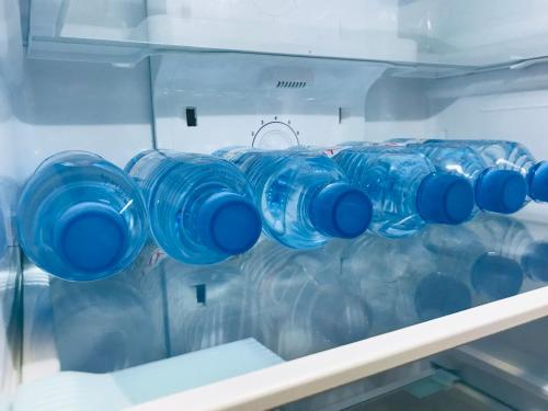 a bunch of blue glasses sitting in a refrigerator at VNVP Apartment in Štip