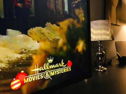 a tv sitting on a desk next to a lamp at VNVP Apartment in Štip
