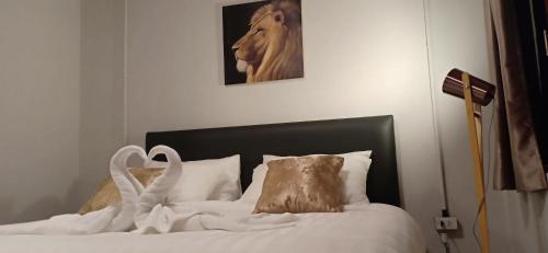 a bedroom with a bed with a horse picture on the wall at MOOK BOONCHU HOTEL in Koh Mook