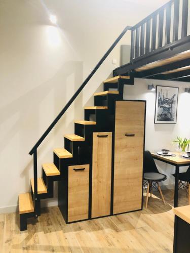 a black staircase with wooden drawers and a desk at Property Apart - Soft Lofty Legnicka Centrum in Wrocław