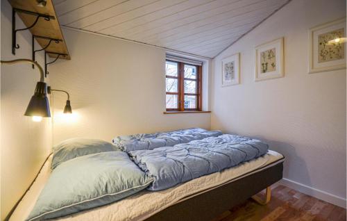 a bed in the corner of a room at 2 Bedroom Cozy Home In Eg in Skæring