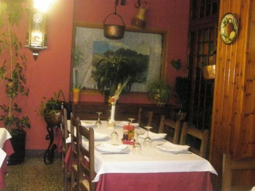 a table in a restaurant with a white table cloth at Hostal Vall D'Aneu by Arcas & Sambola in Esterri d'Àneu