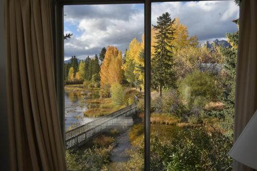 a window with a view of a river at The Drake Inn in Canmore