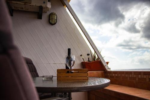 a wine glass sitting on a table on a boat at Looking the VIEWS - 214 in Costa Del Silencio