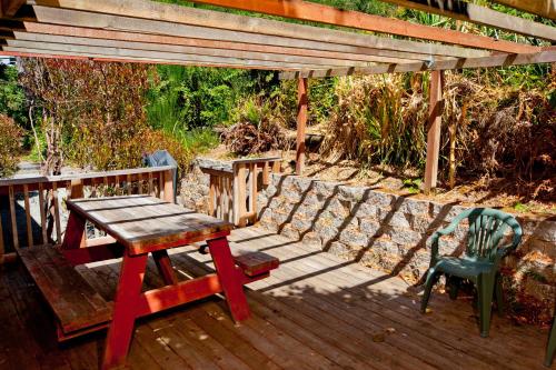 a wooden table and chairs sitting on a deck at View Crest Lodge in Trinidad
