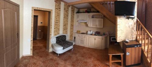 a kitchen with a chair and a sink in a room at Котедж Relax Yaremche in Yaremche