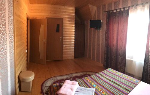 a bedroom with a bed and a door to a hallway at Котедж Relax Yaremche in Yaremche