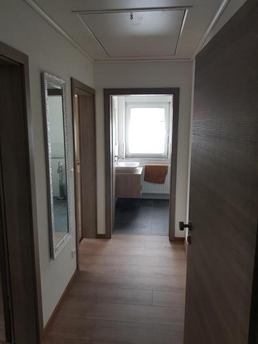 a hallway with a door and a window and a sink at FEWO Jürgen + Conny in Babenhausen