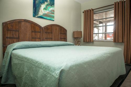 a bedroom with a large bed and a window at Ragged Edge Resort & Marina in Islamorada