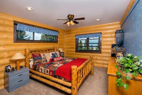 una camera con letto in legno e ventilatore a soffitto di Fish Creek House Bed & Breakfast a Silver Star