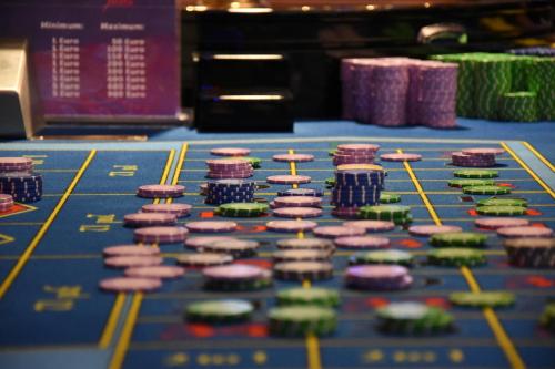 a blue poker table with poker chips on it at Casino Admiral Velenice - Gmünd in České Velenice