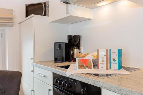 a kitchen with a counter with books on it at Appartementhaus Casamarai in Saalbach Hinterglemm