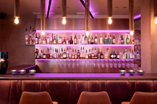 a bar with a lot of bottles of alcohol at Adler Inn Tyrol Mountain Resort SUPERIOR in Tux