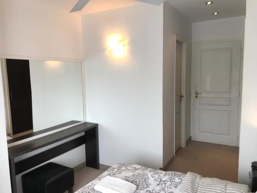 a bedroom with a mirror and a bed and a dressing table at Hotel Europa in Ostende