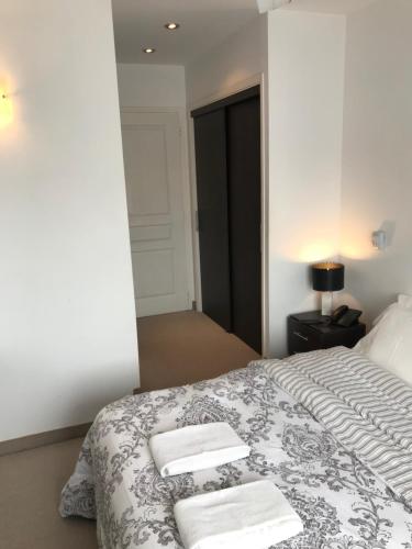 a bedroom with a bed with two towels on it at Hotel Europa in Ostende
