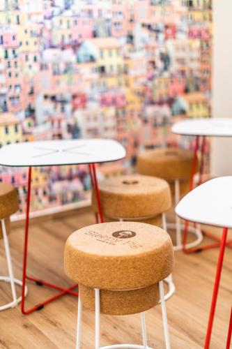 a group of tables and stools in front of a window at Sleepyfig in Sagres