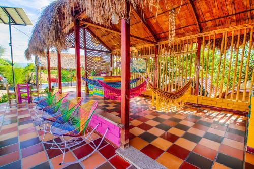a patio with chairs and a table and swings at Dunas Tatacoa in Villavieja