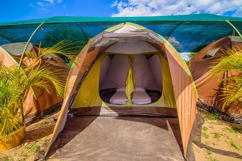 a tent with a chair inside of it at Dunas Tatacoa in Villavieja