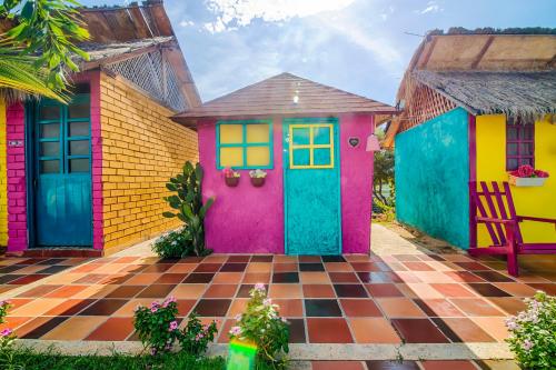 a colorful house with a colorful front door at Dunas Tatacoa in Villavieja