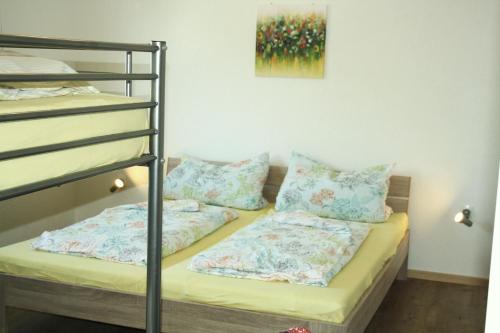 a bunk bed with pillows on top of it at Ferienhaus Cilla in Beltheim