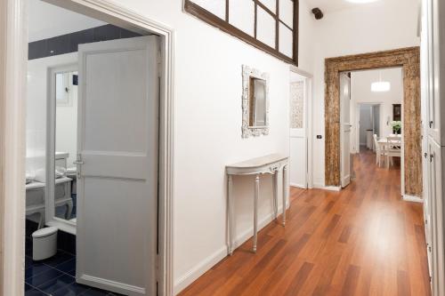 a hallway with white walls and a wooden floor at Leonardo Suite Pantheon in Rome
