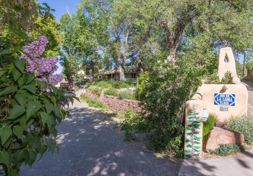 a garden with a sign that says get ready tovote at Inn on La Loma Plaza in Taos