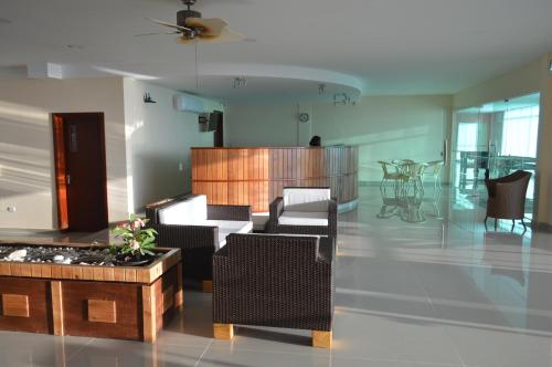 a large living room with chairs and a table at Residences Sommet Port Salut in Port-Salut