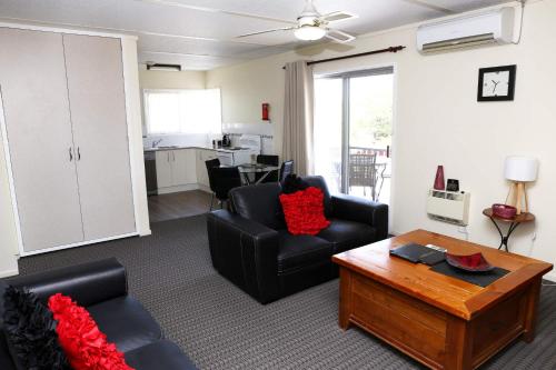 a living room with two chairs and a coffee table at Westwood Motor Inn in Armidale