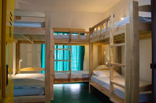 a room with three bunk beds in a hostel at Green Nest Hostel, Baga - Arpora in Arpora
