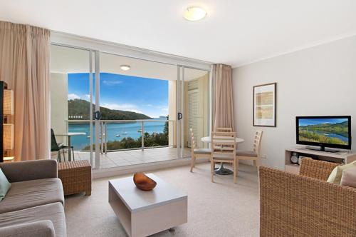 a living room with a view of the ocean at Ettalong Beach Luxury Apartments in Ettalong Beach